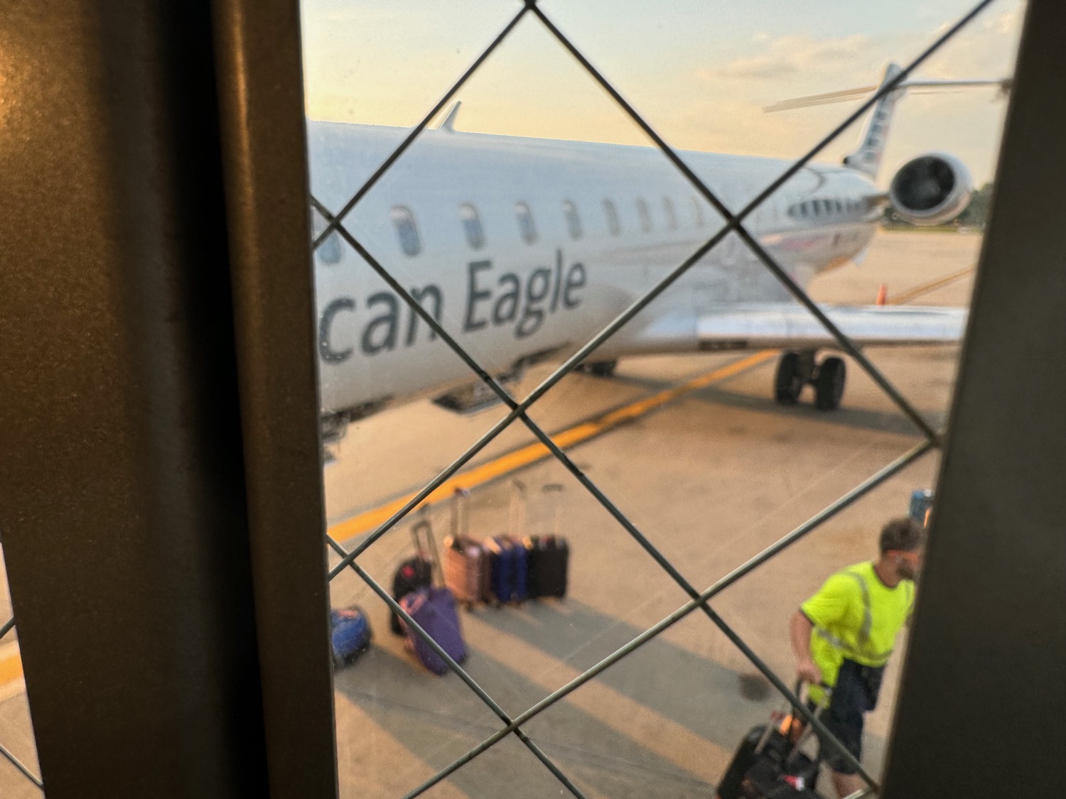 a window with a plane and luggage