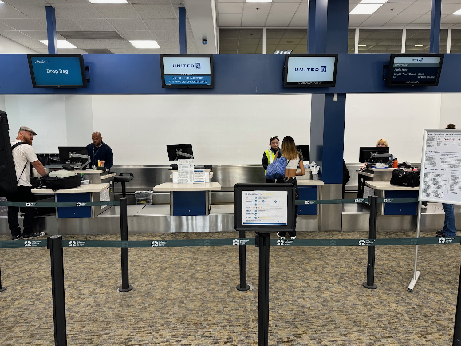 people in an airport check in counter