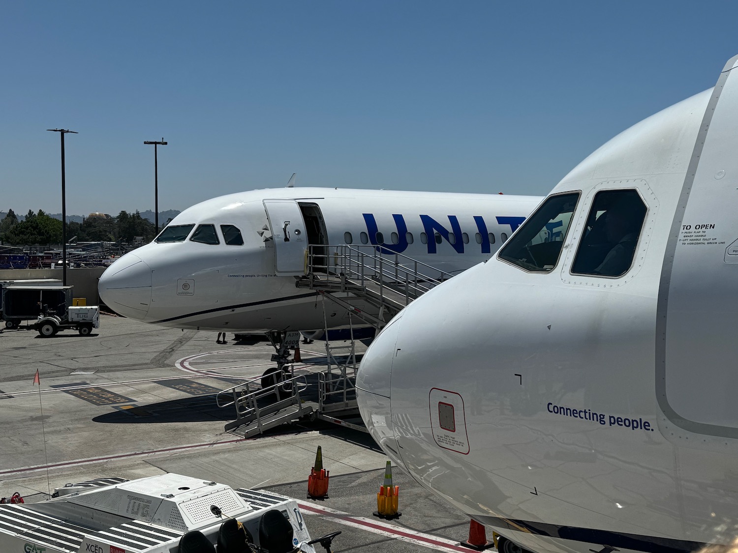 a group of airplanes parked at an airport