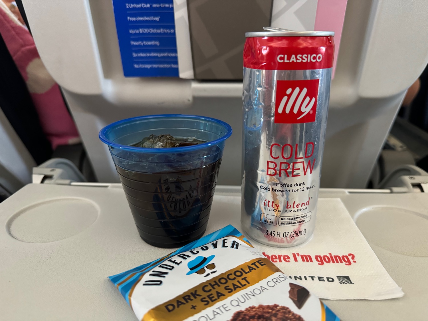 a can of beverage and a drink on a tray