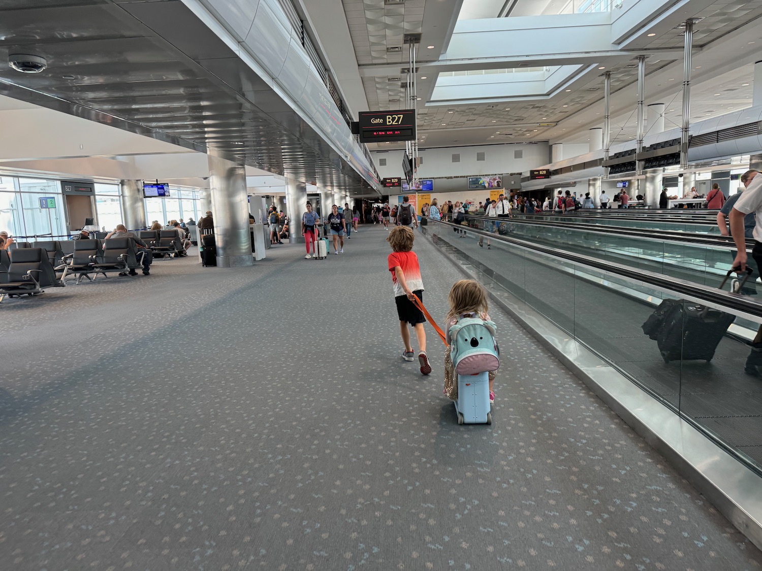 a group of people walking in an airport