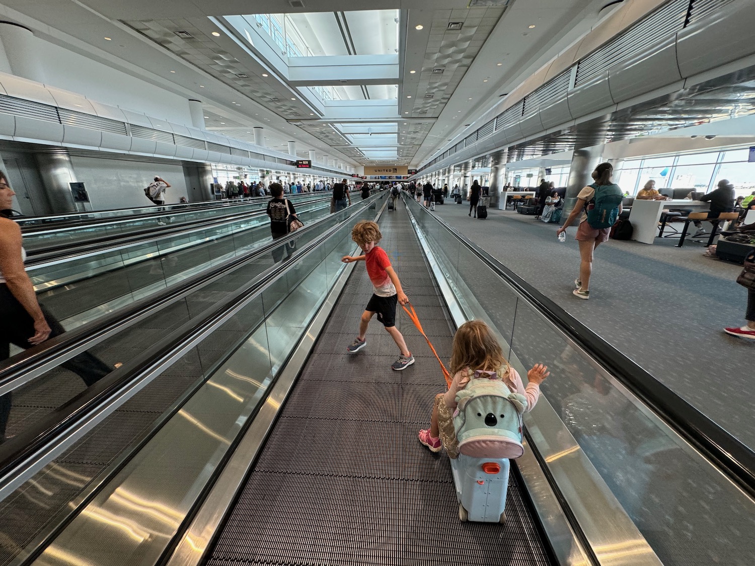 a boy and girl on an escalator