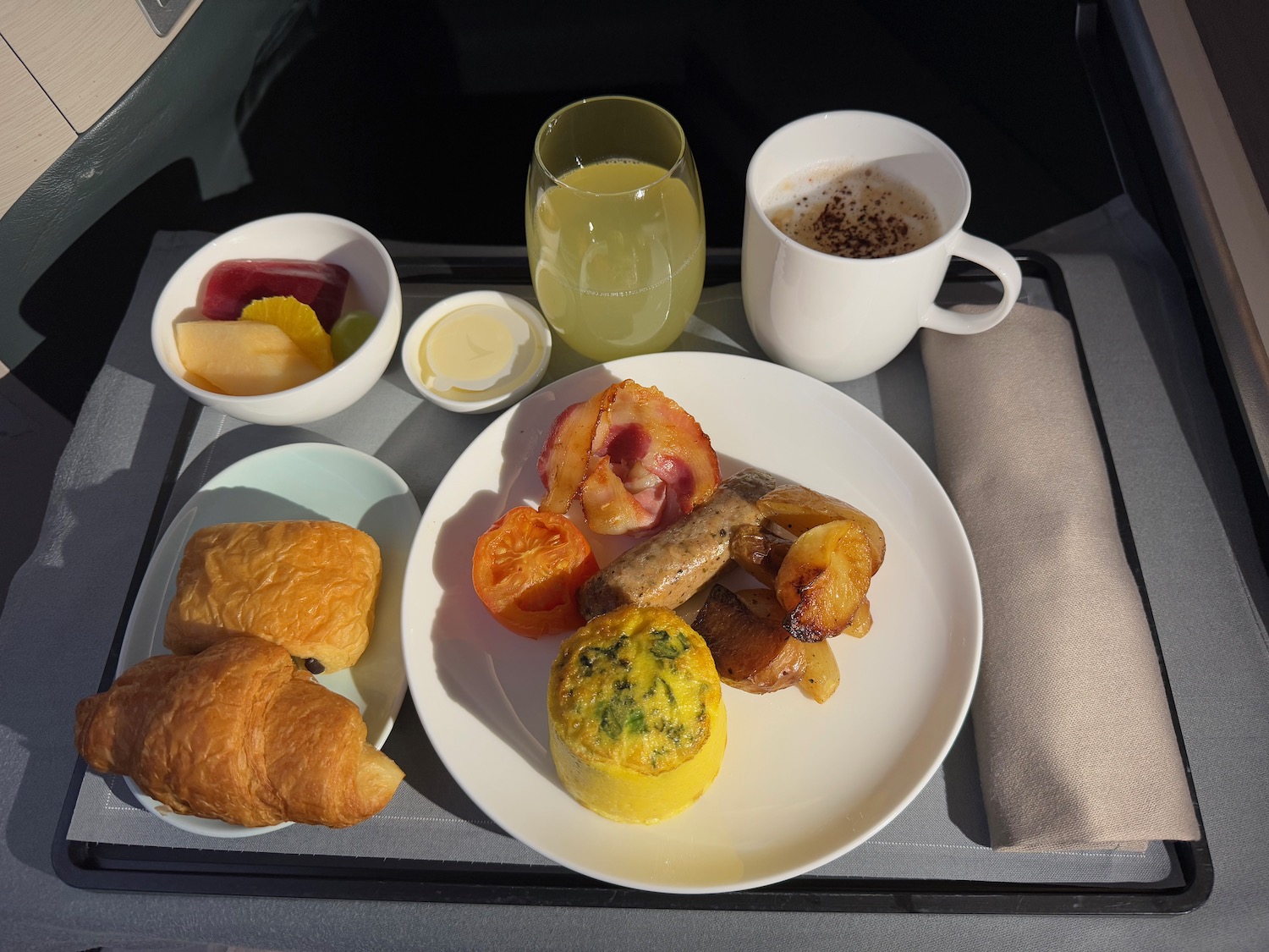 a plate of food and drinks on a tray