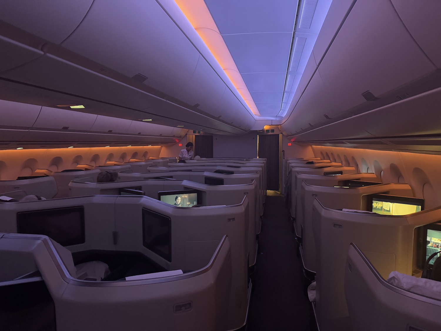 an airplane with rows of seats and monitors