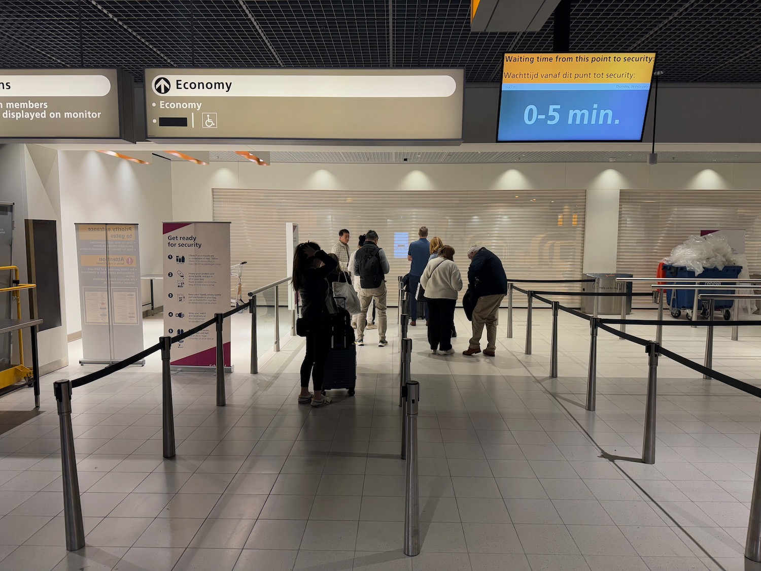 people standing in a line in a airport