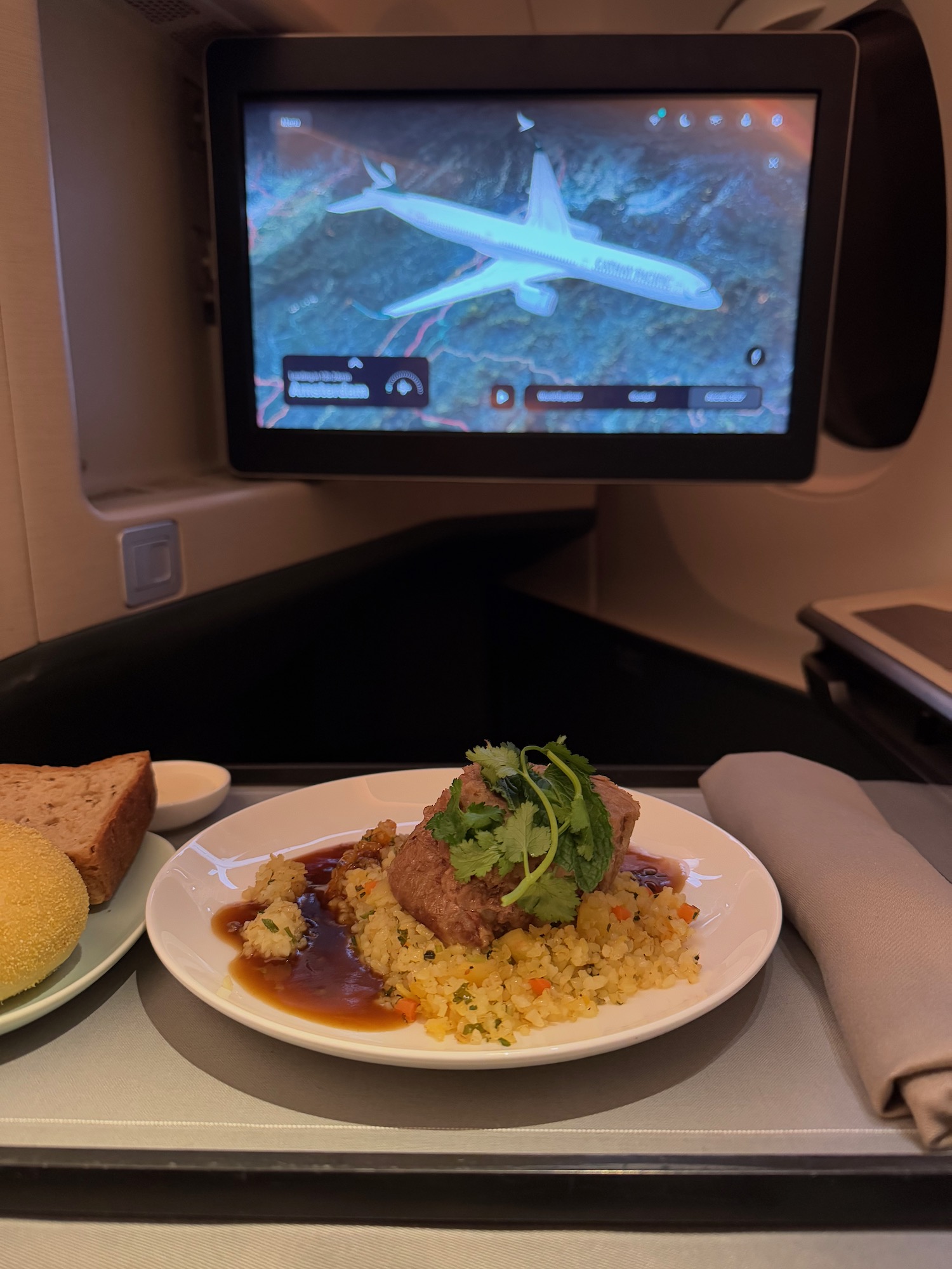 a plate of food on a table with a television in the background