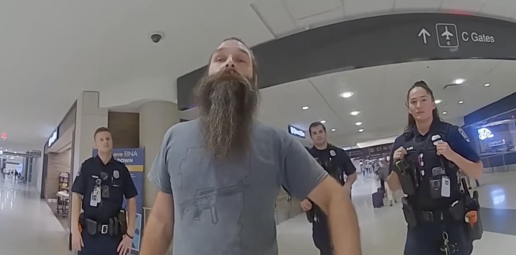 a man with a long beard in a airport