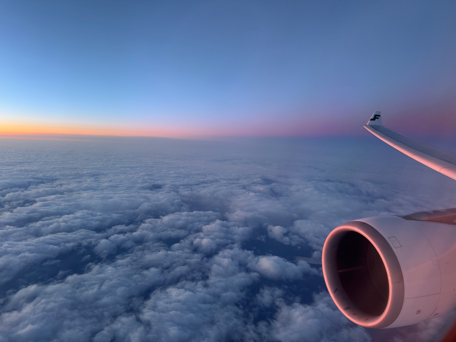 an airplane wing and clouds