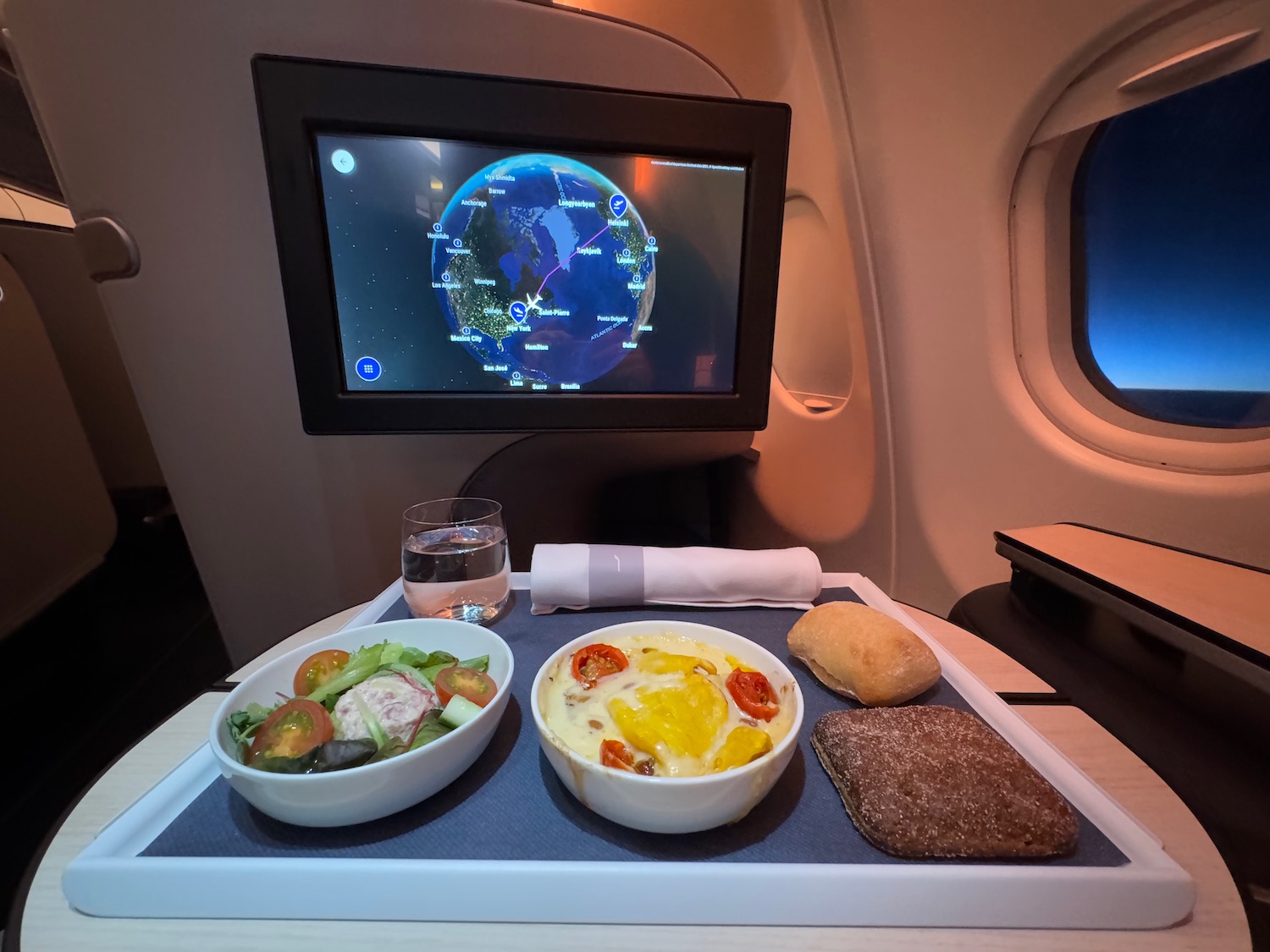 a tray of food on a table in an airplane