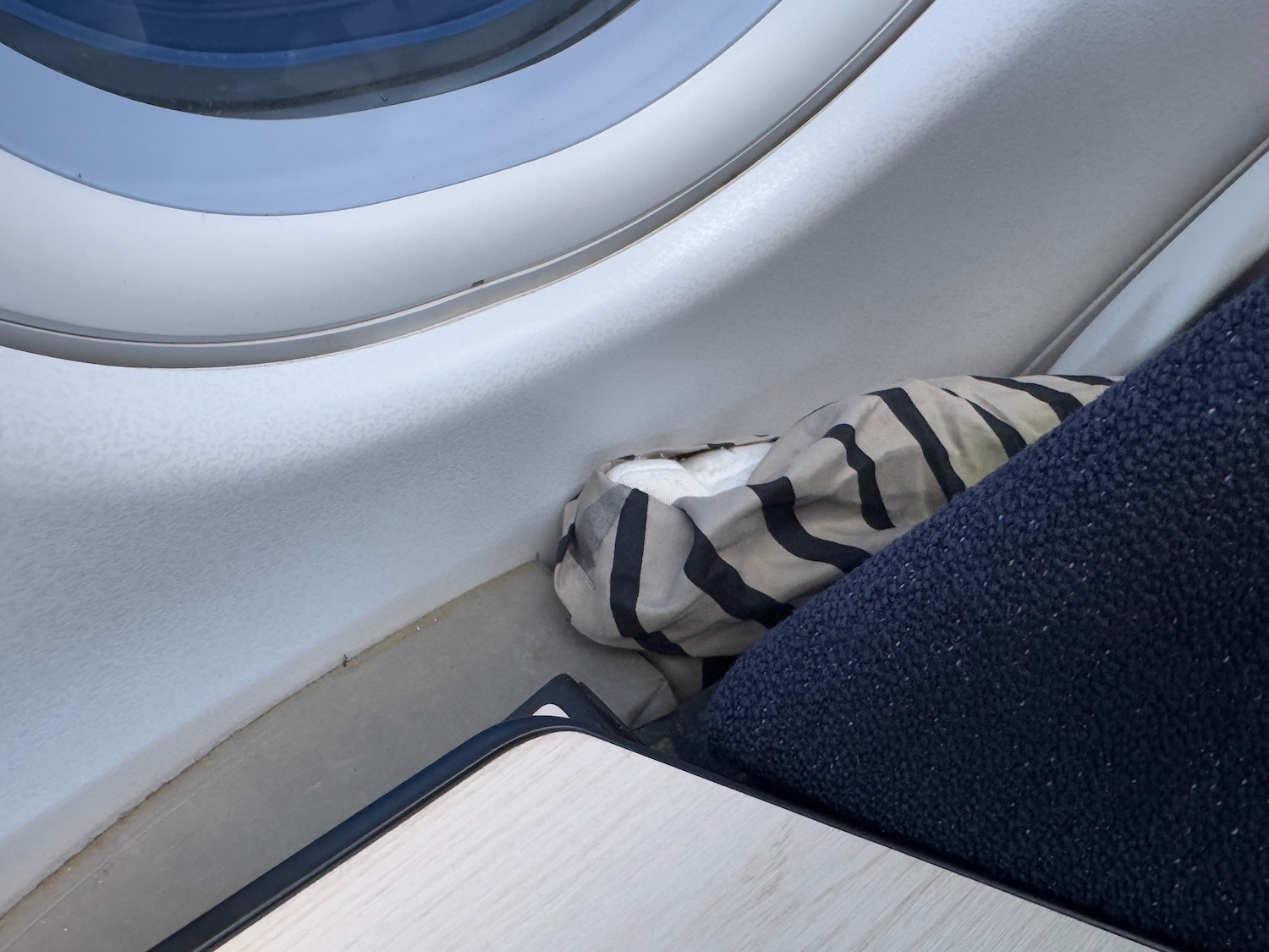 a striped pillow on a window