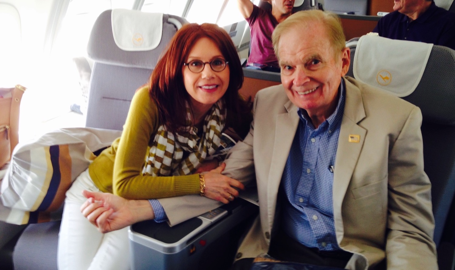 a man and woman sitting on a plane