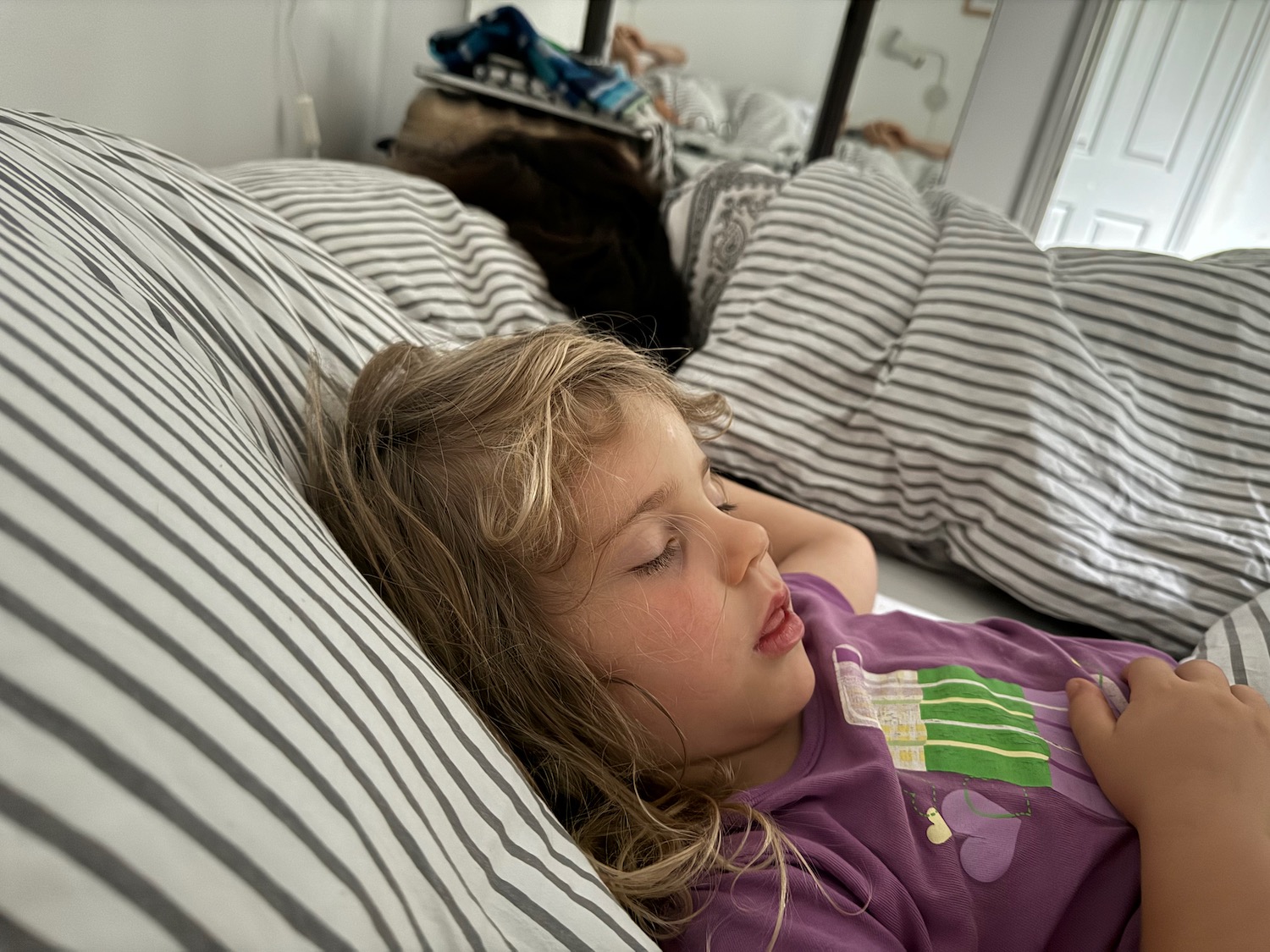 a girl sleeping on a bed