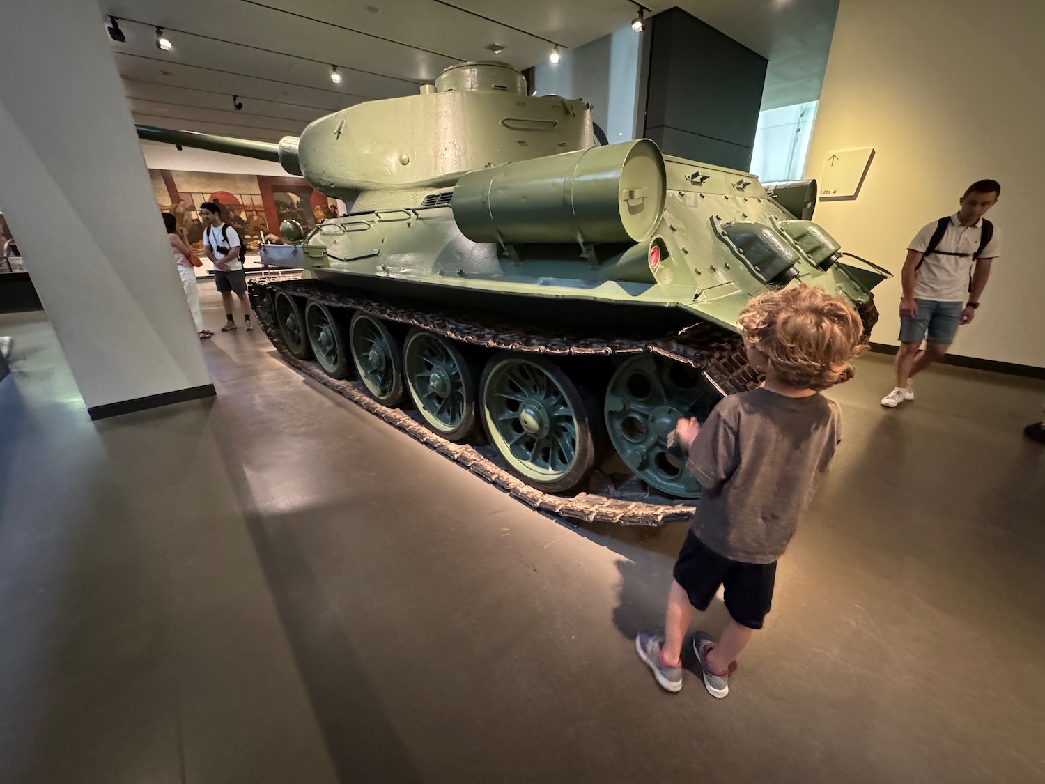 a boy looking at a tank