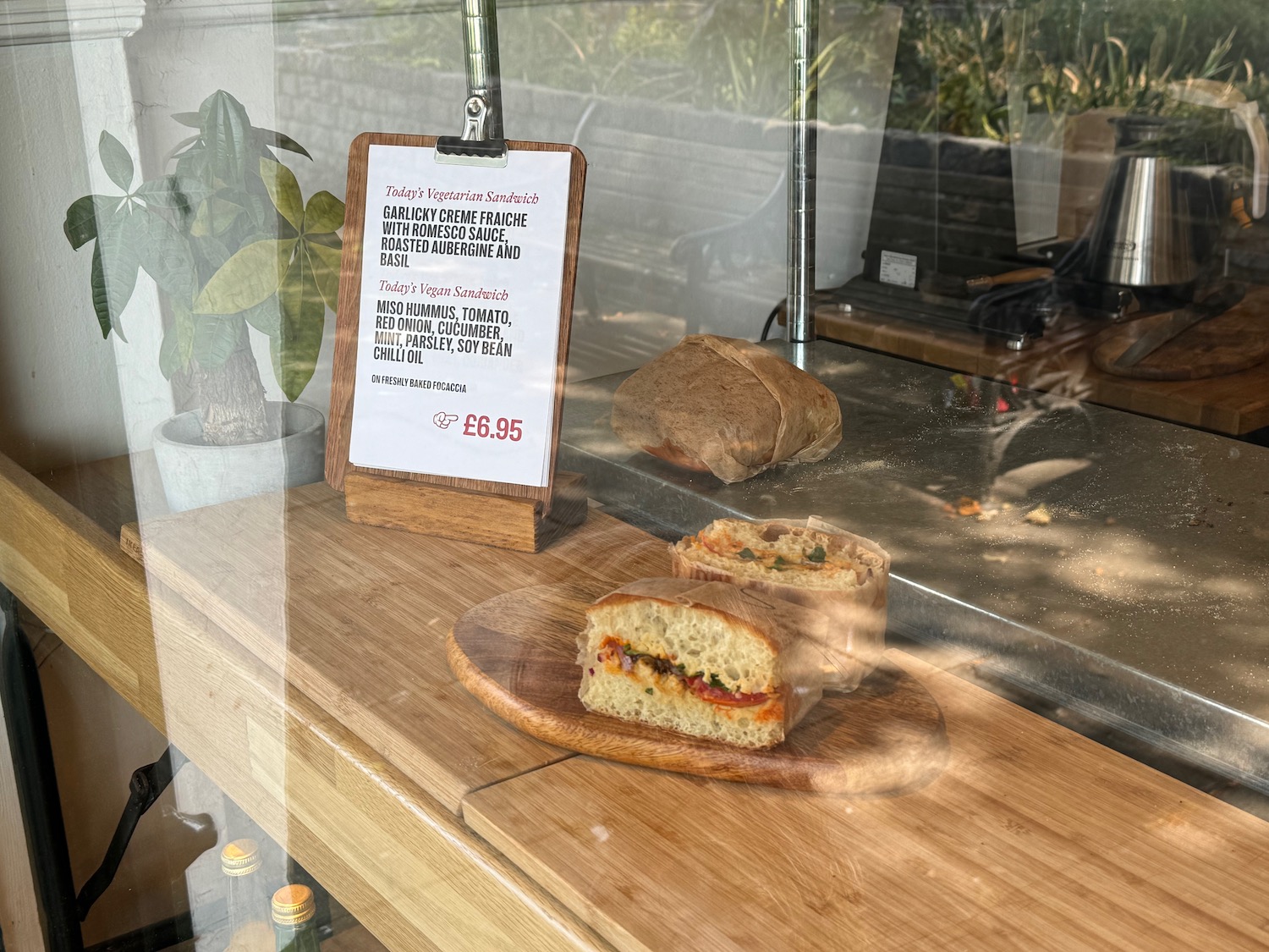 a sandwich on a wood plate