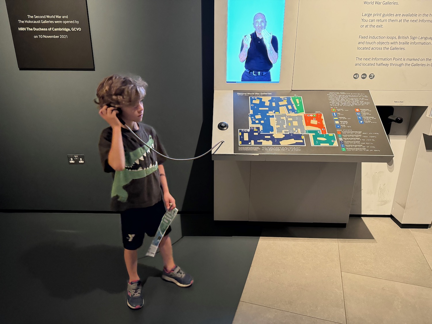 a boy holding a phone to his ear