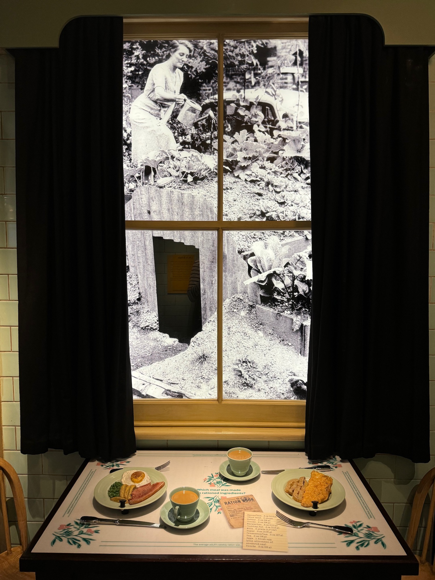 a table with food on it and a window with a woman in the background