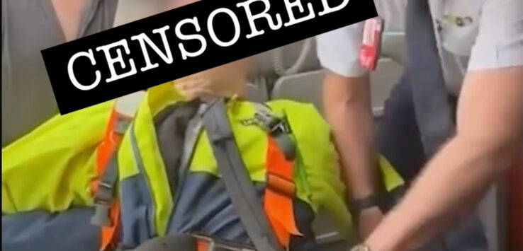 a man looking at a person in a safety vest