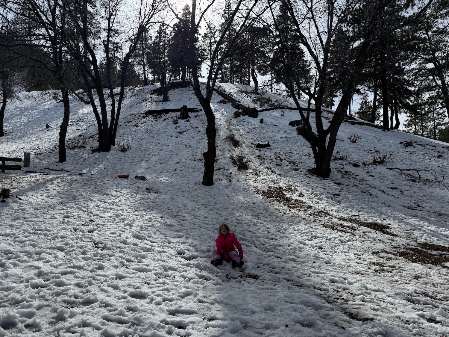 a girl sitting in the snow