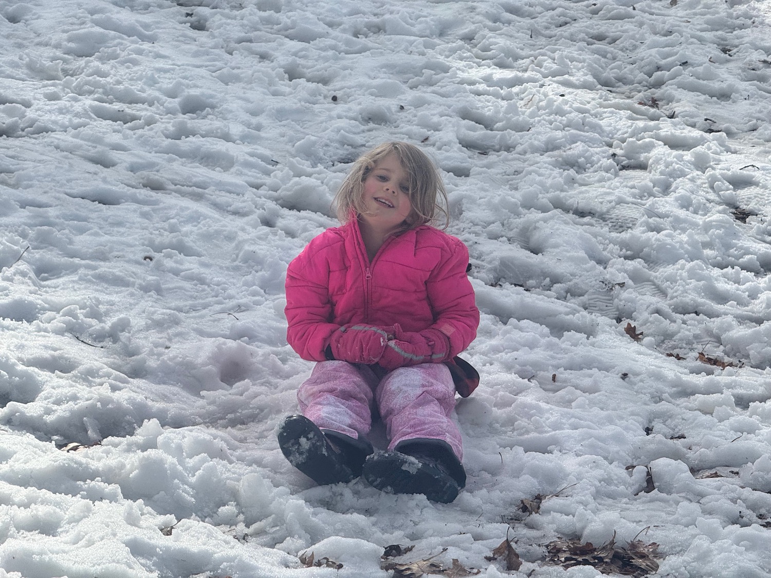 a girl sitting in the snow