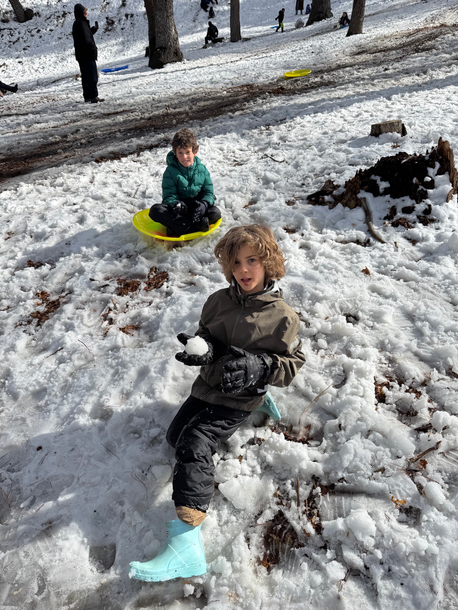 two children sitting in snow