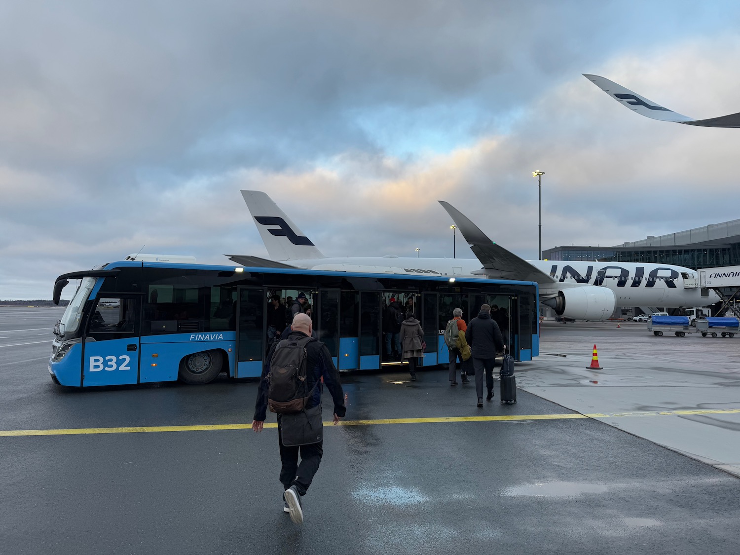 a group of people walking next to a bus