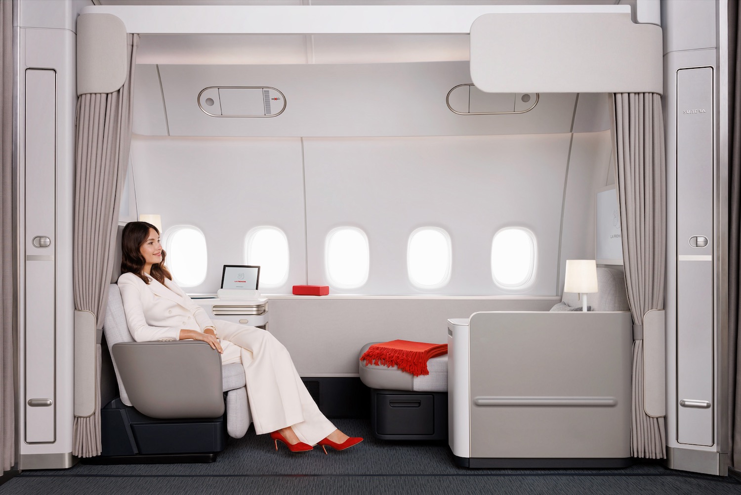 a woman sitting in a chair in a plane