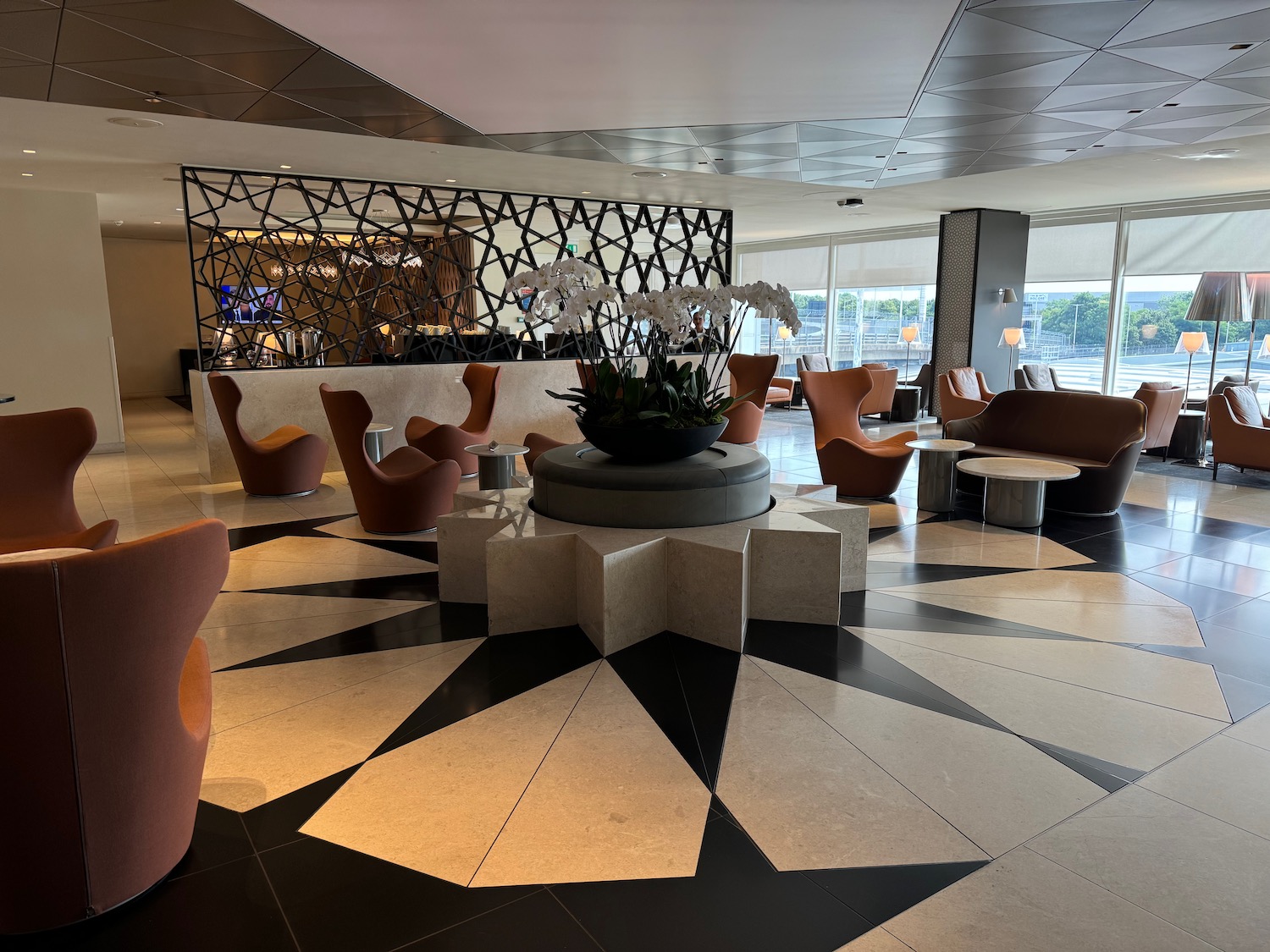 a room with a black and white patterned floor and chairs