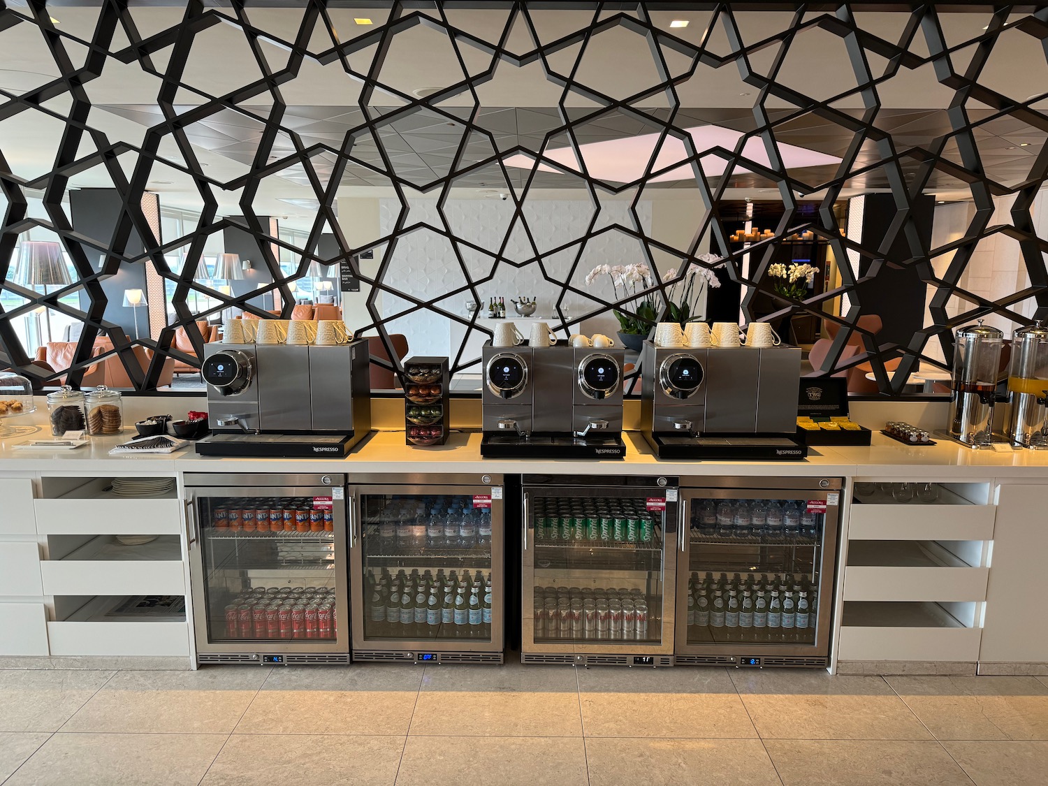 a coffee machine and beverage coolers in a room