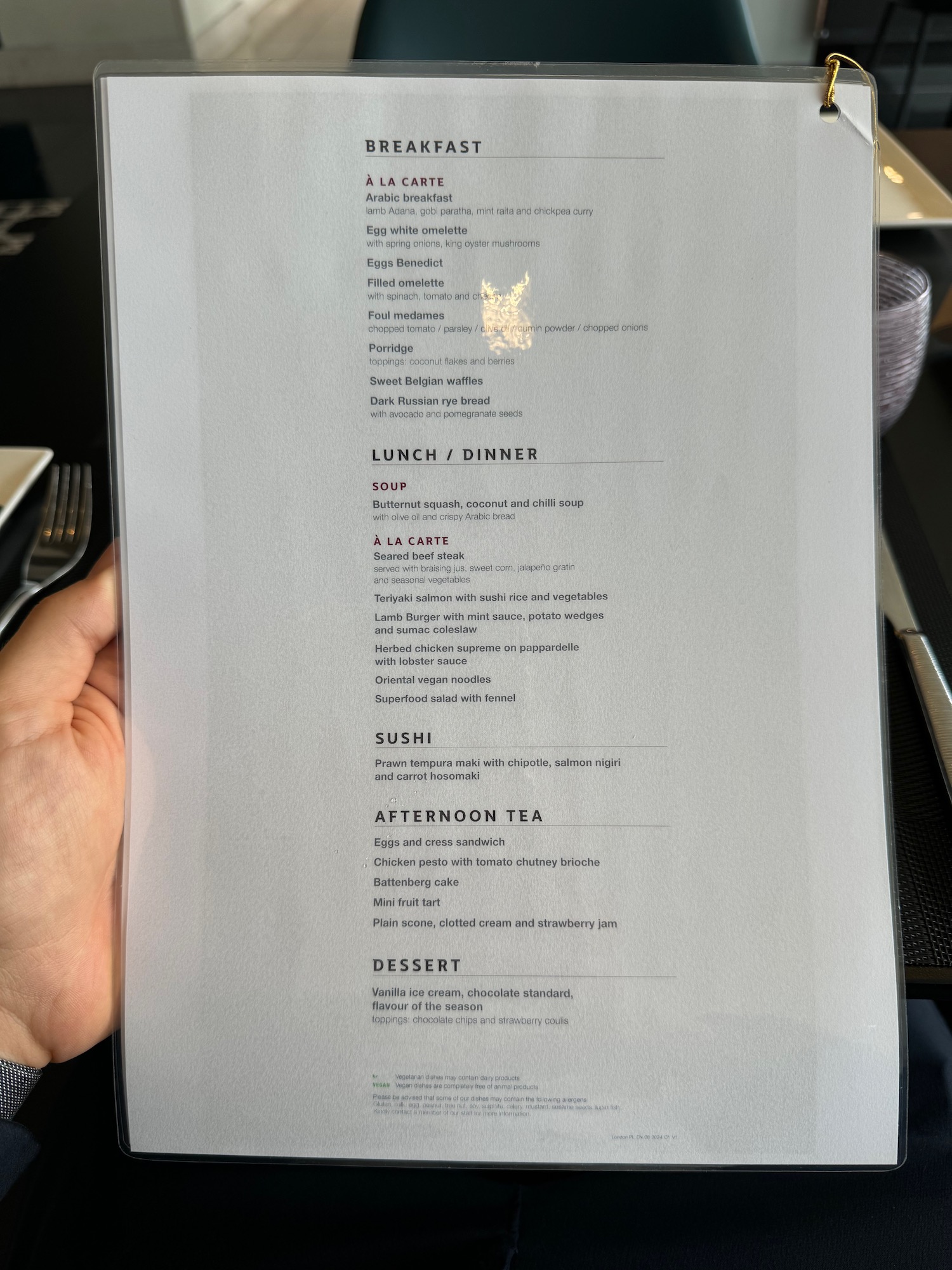 a hand holding a menu