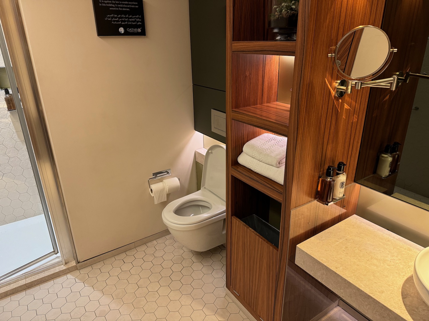 a bathroom with a toilet and shelves