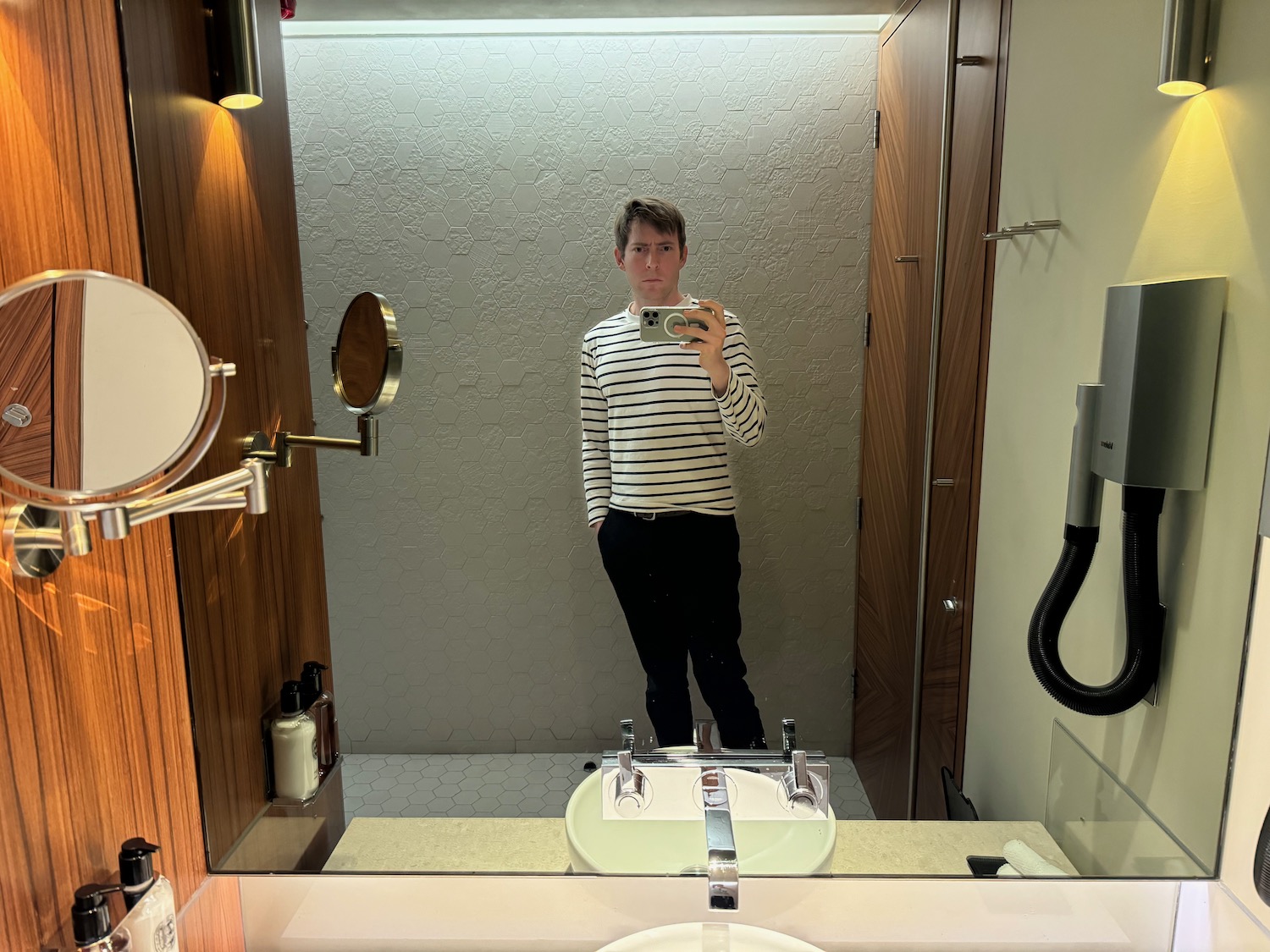 a man taking a selfie in a bathroom