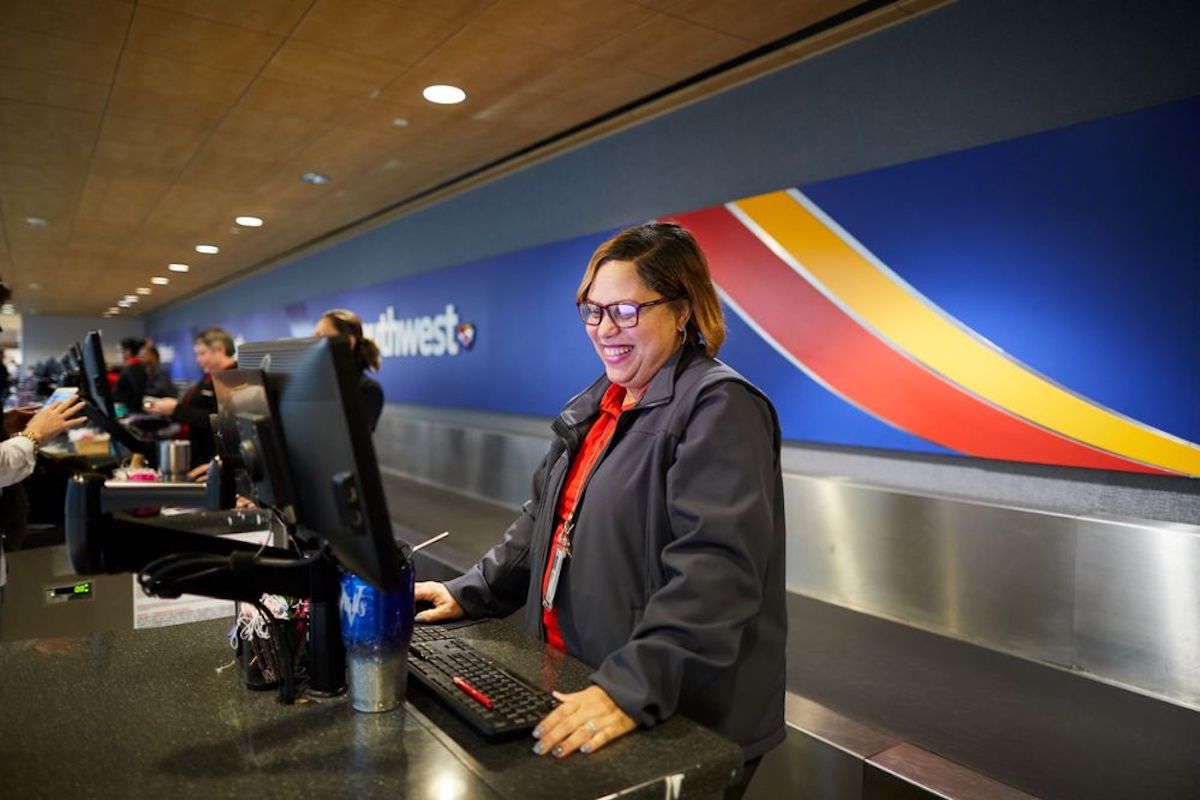 a woman smiling at a computer