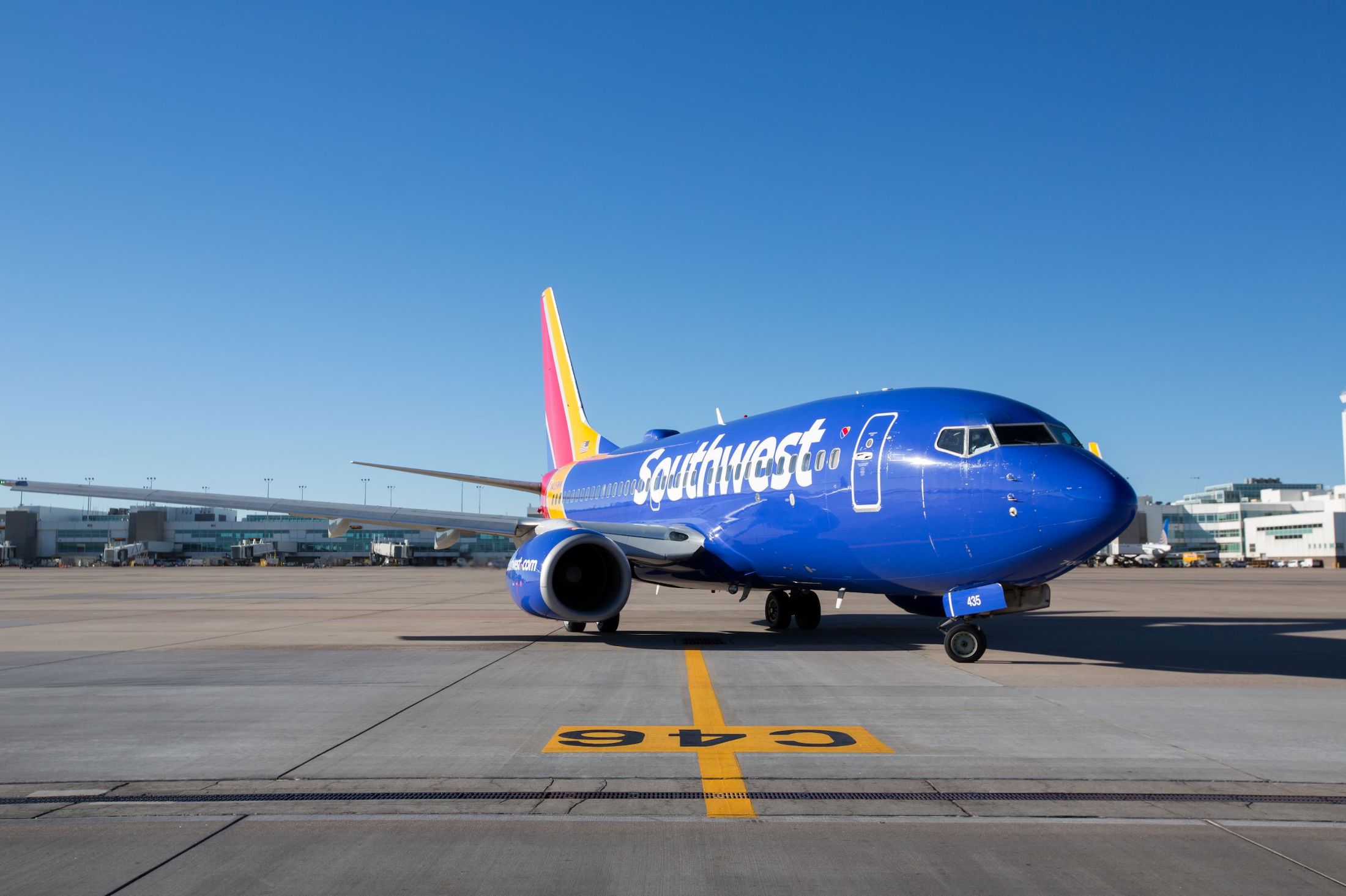 a blue airplane on a runway