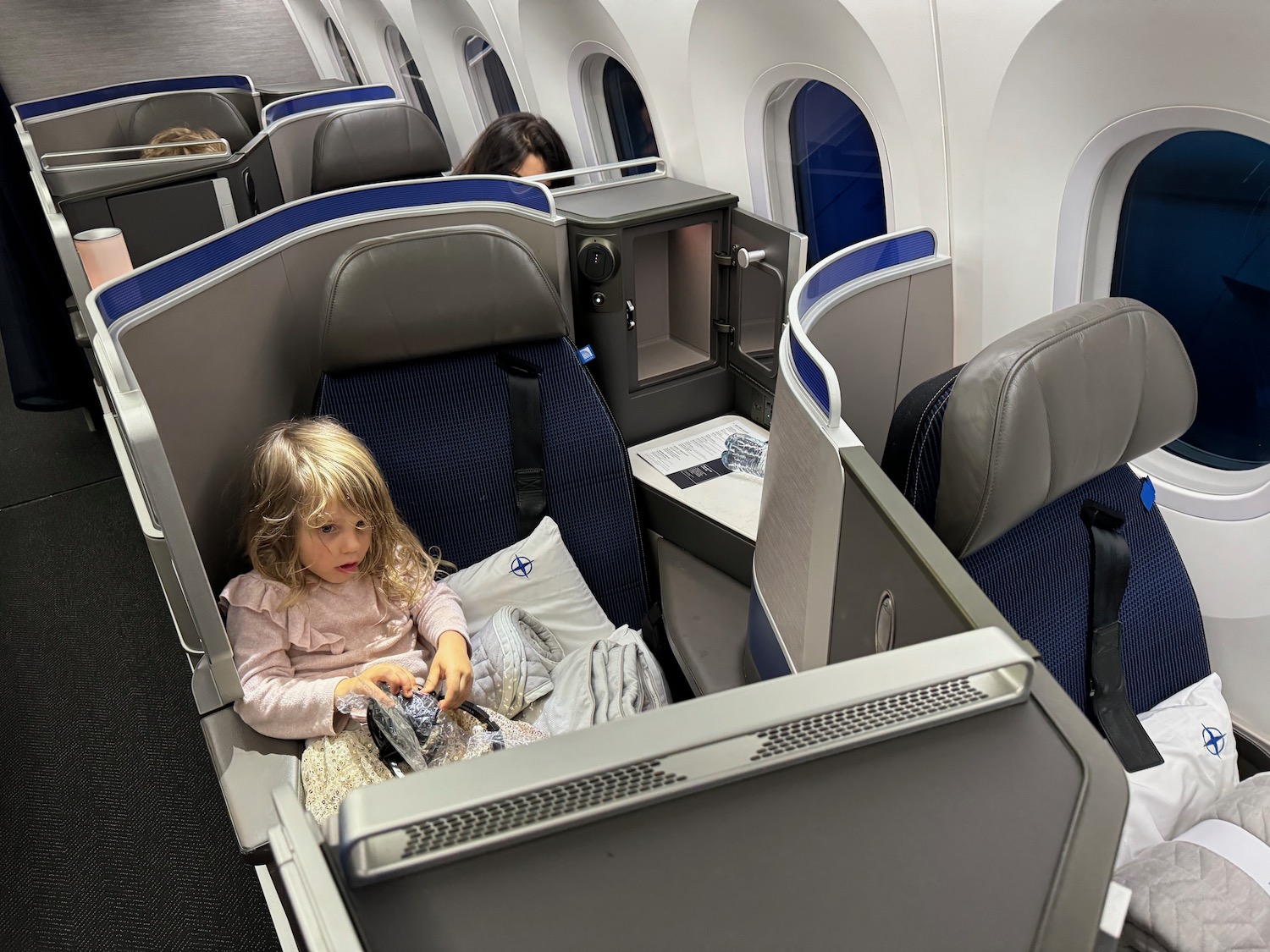 a child sitting in a seat on an airplane