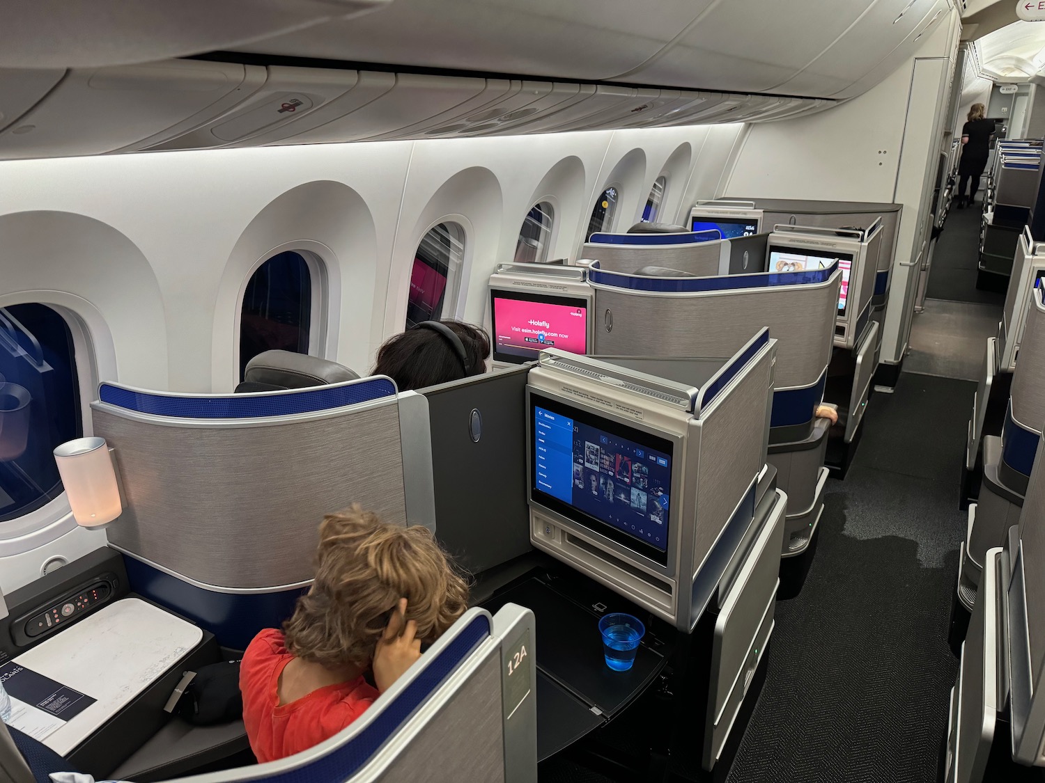 people sitting in an airplane with a computer