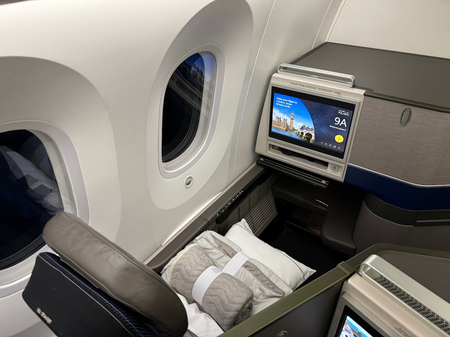 a seat with a tv and a bed in the middle of the seat