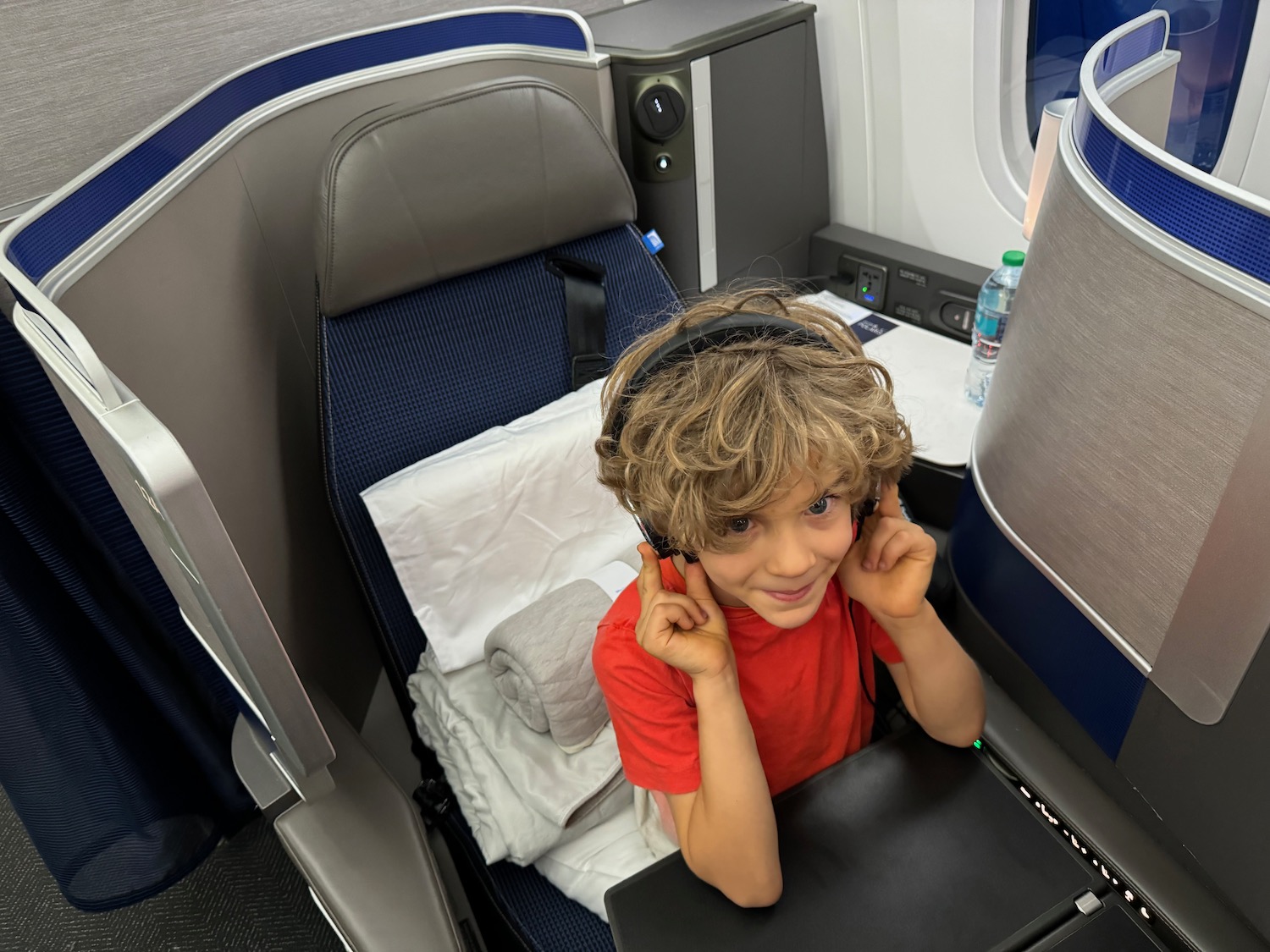 a boy sitting in a chair with headphones on