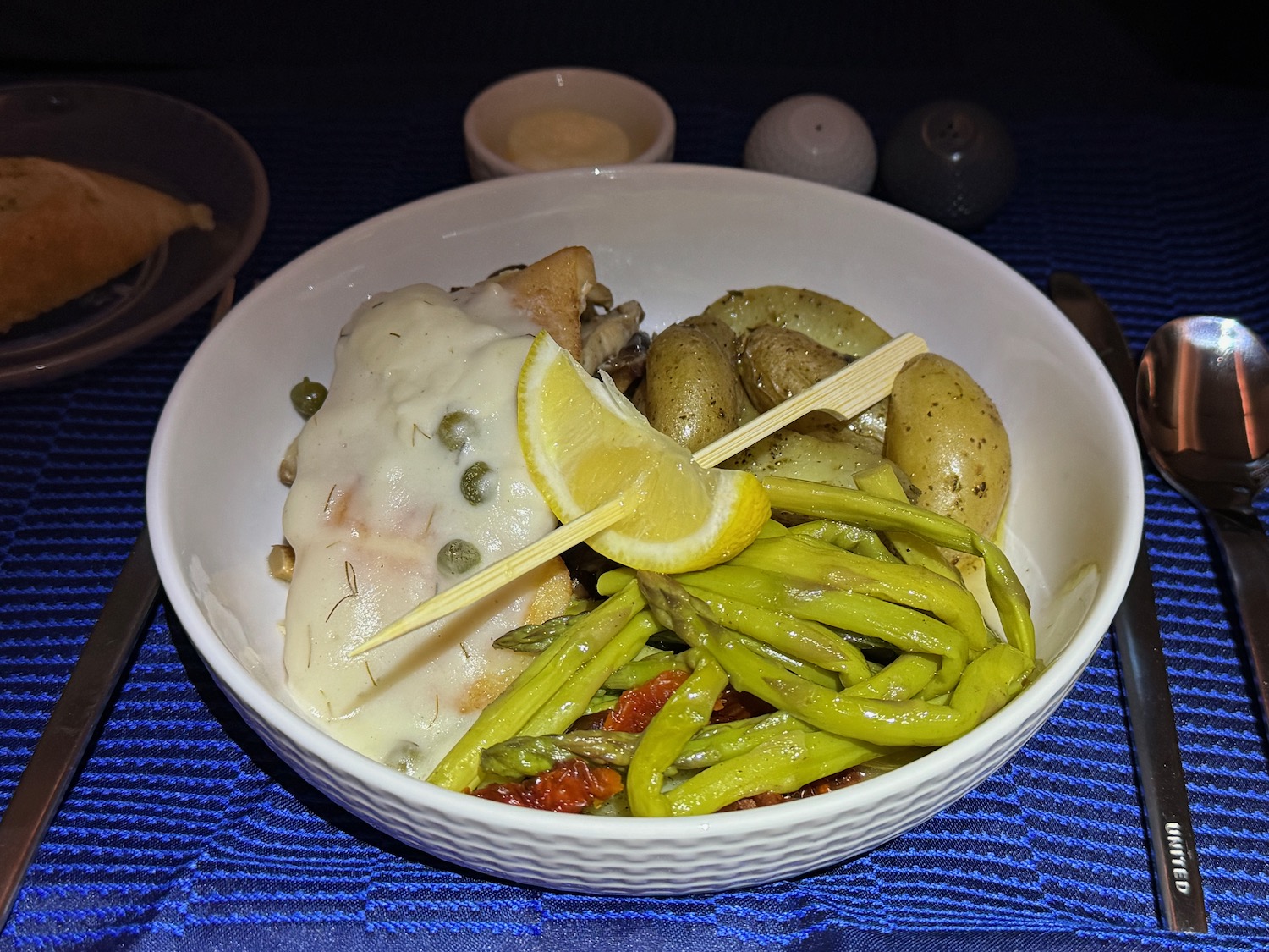 a bowl of food with a lemon wedge