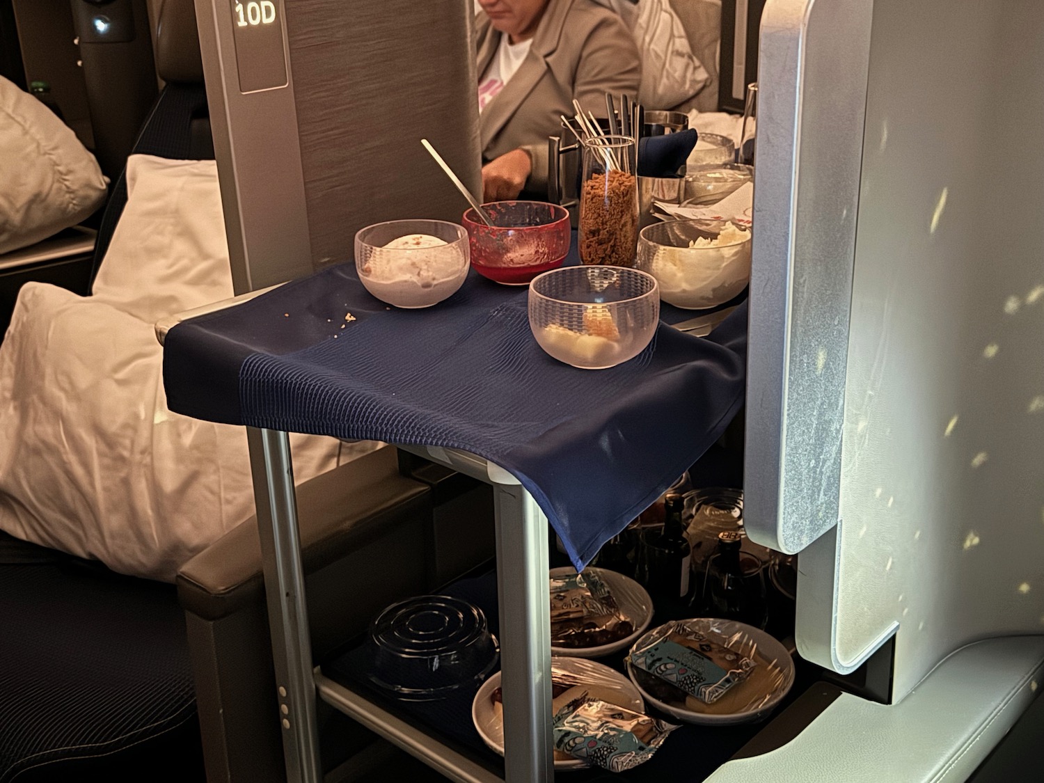 a woman sitting in a chair with a table full of food