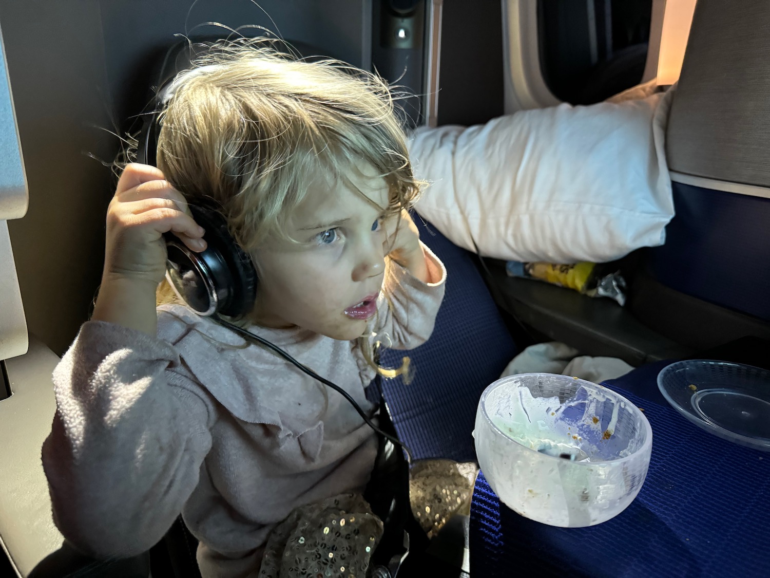 a child wearing headphones and looking at something