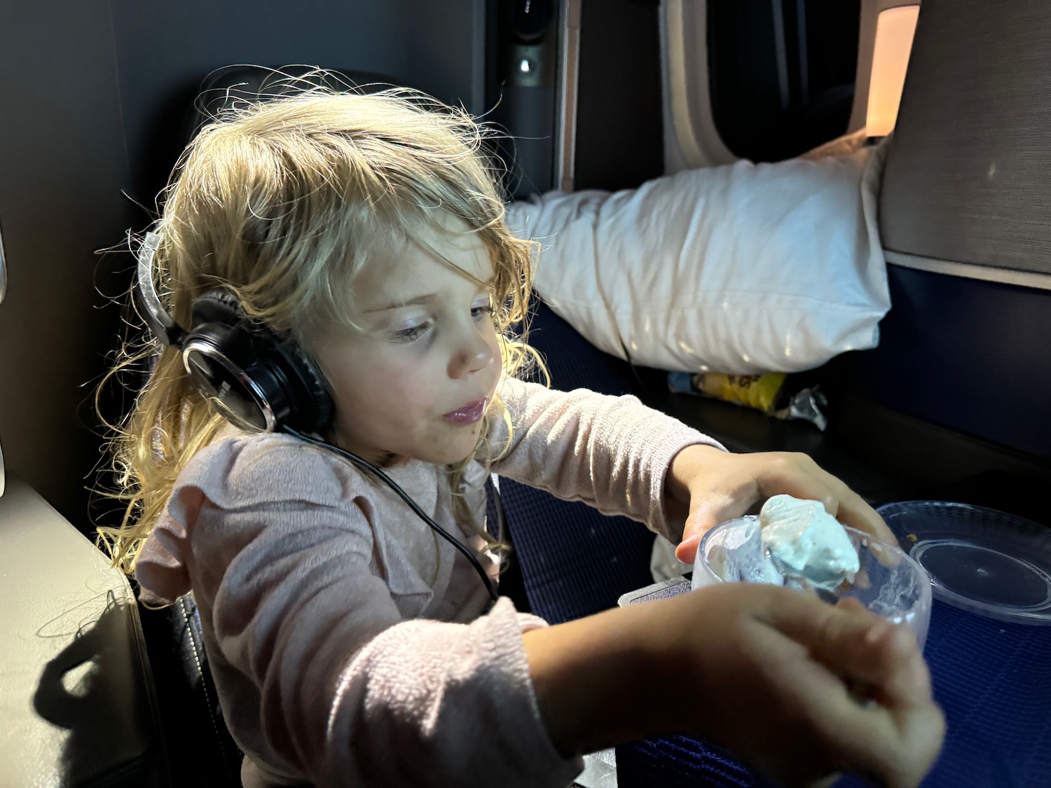 a child wearing headphones and eating food