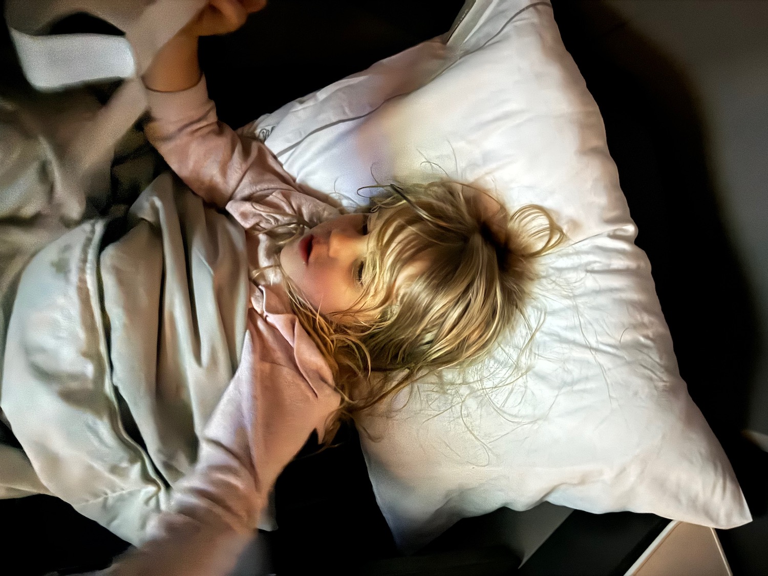 a child lying on a pillow