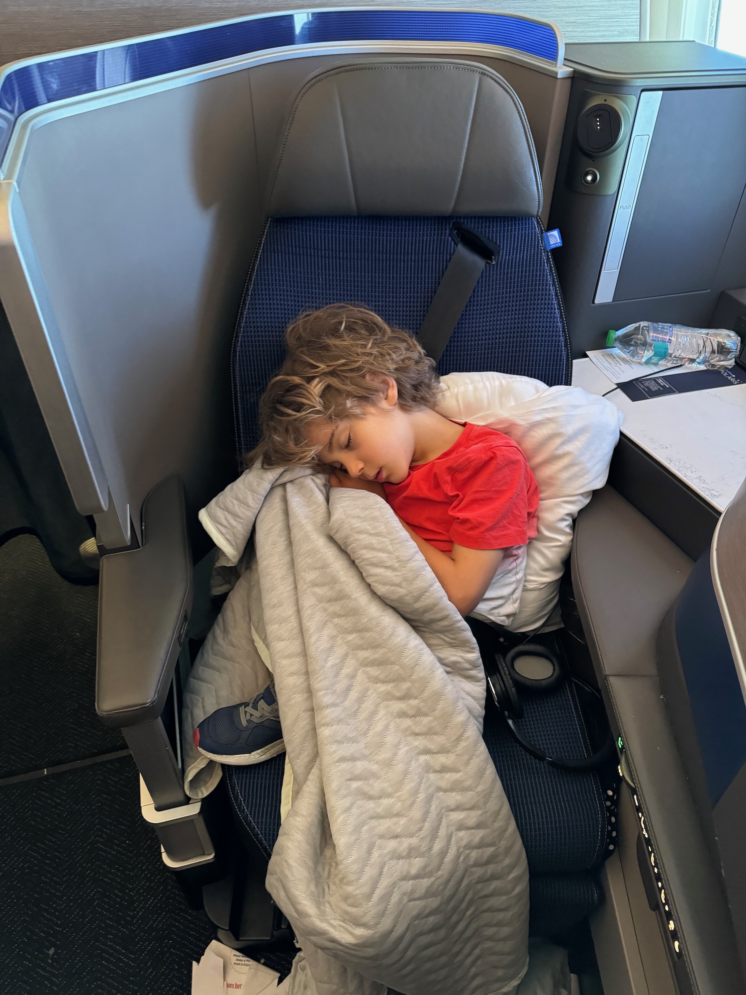 a child sleeping on a seat