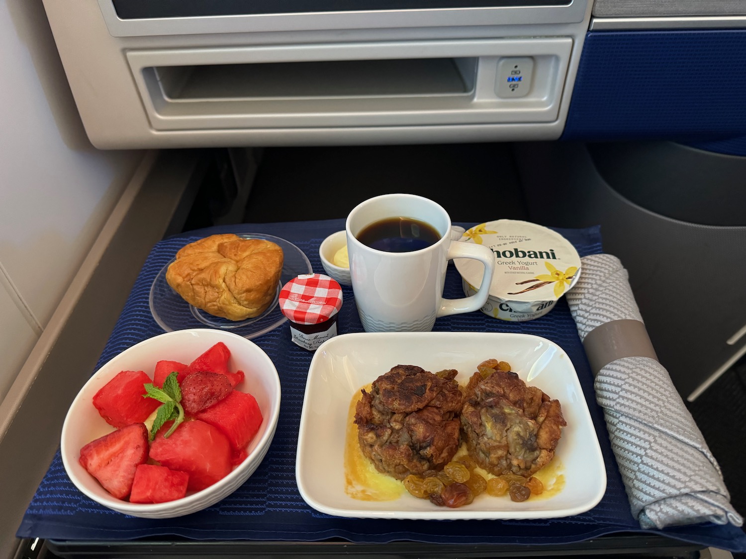 a tray of food and a cup of coffee on a blue tray