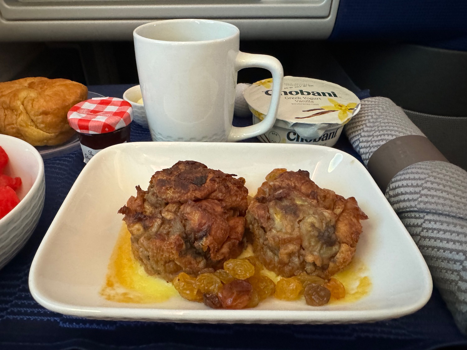 food on a plate with a cup of coffee and a mug