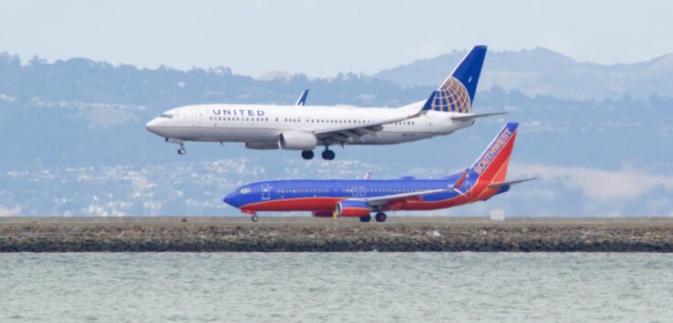 a group of airplanes on a runway