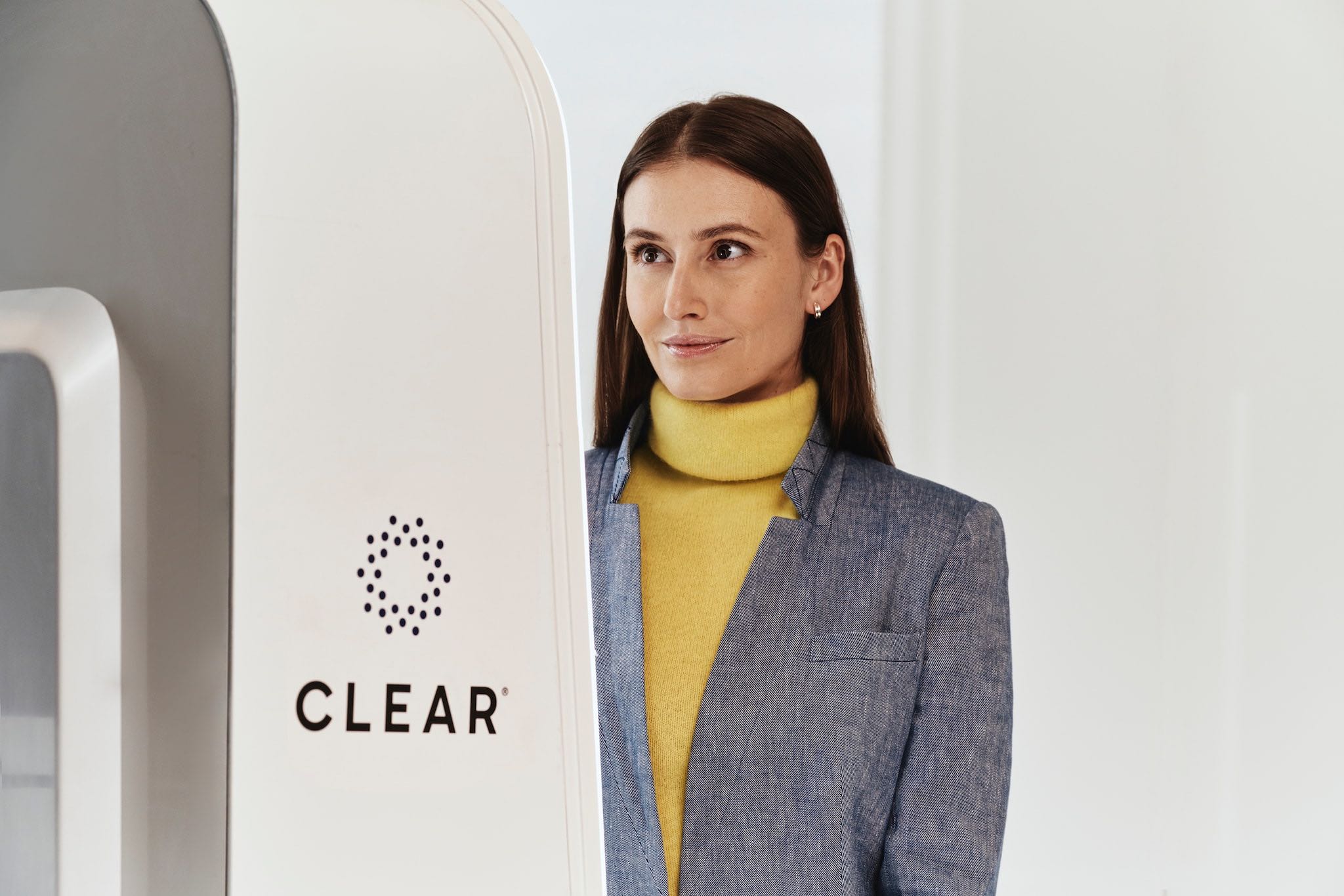 a woman standing next to a white object