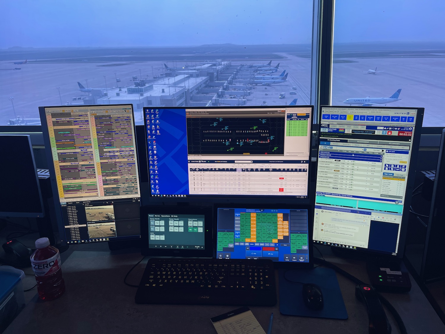 a group of computer monitors and keyboard