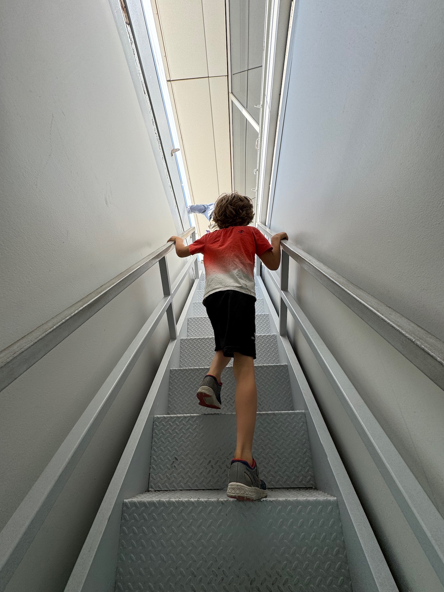 a boy walking up a staircase