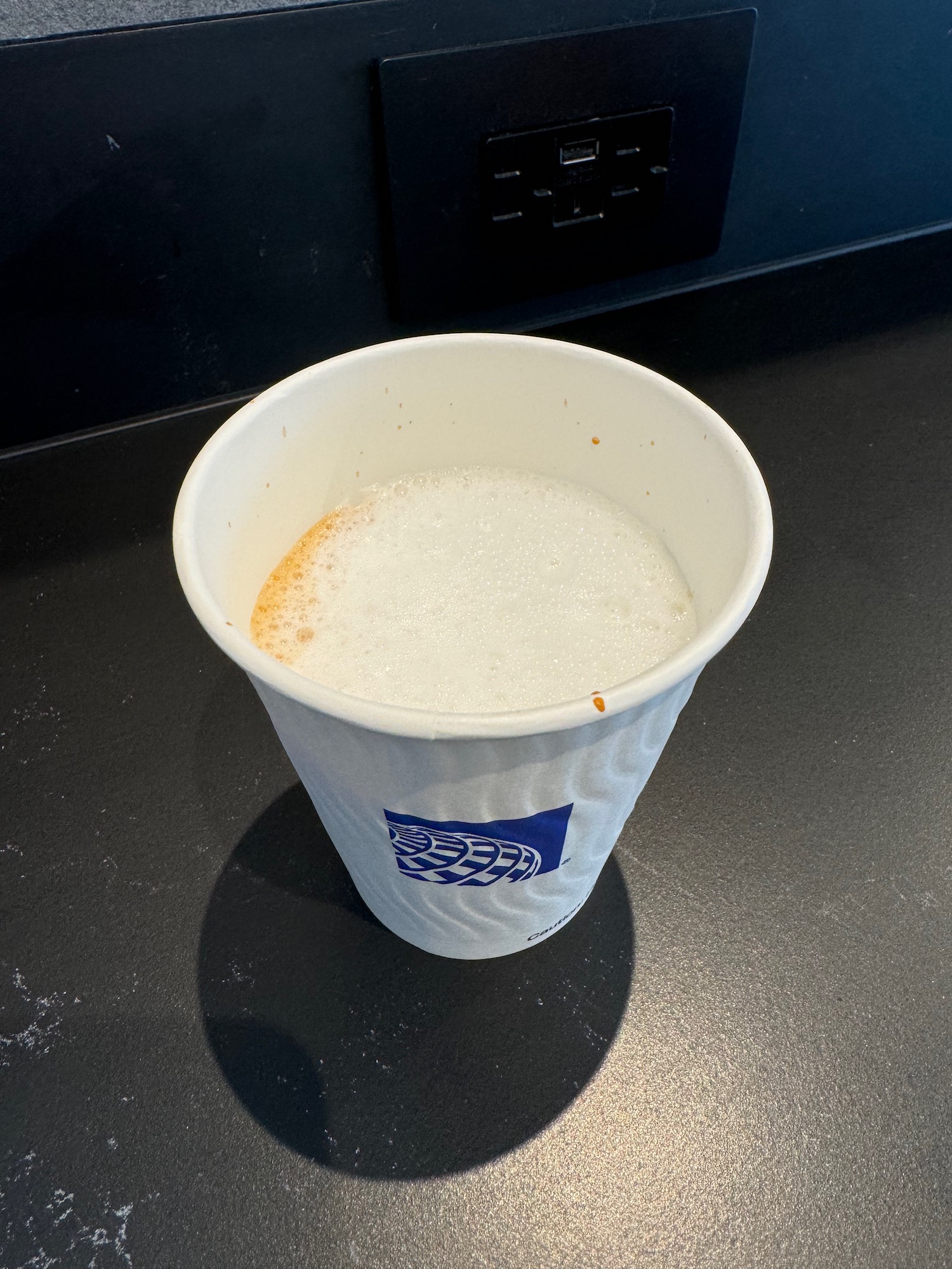 a cup of coffee with foam in it